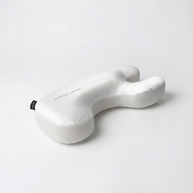 Woman resting on the Beauty Bear Memory Foam Skincare Pillow demonstrating comfortable positioning for preventing sleep wrinkles